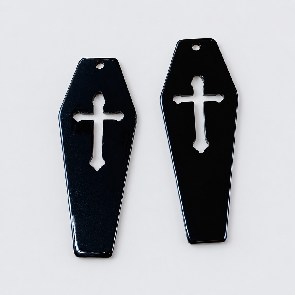 A coffin-shaped memorial pendant setting on a chain.