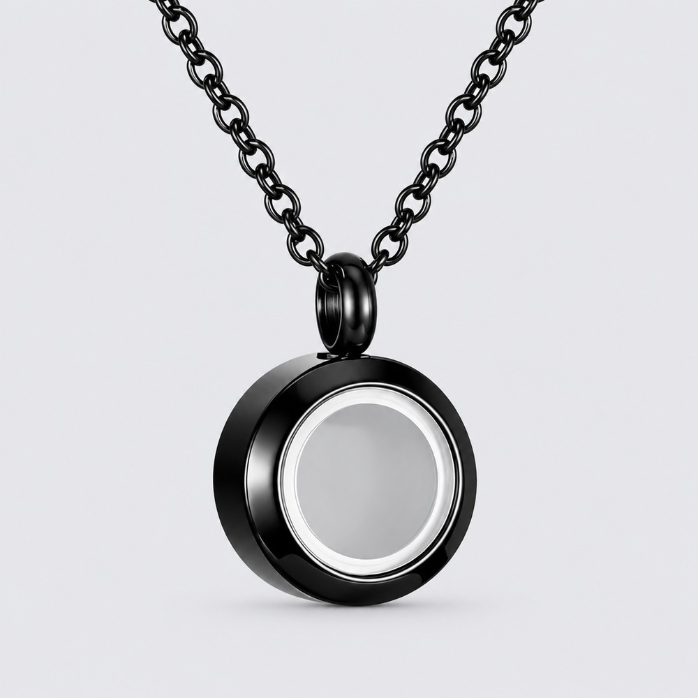 A small round memorial pendant setting on a dark chain.