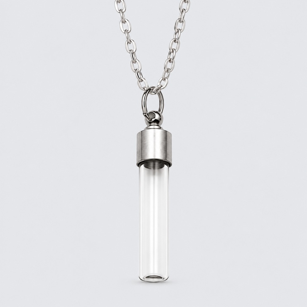 A clear cylindrical keepsake vial with a silver-coloured cap and chain.