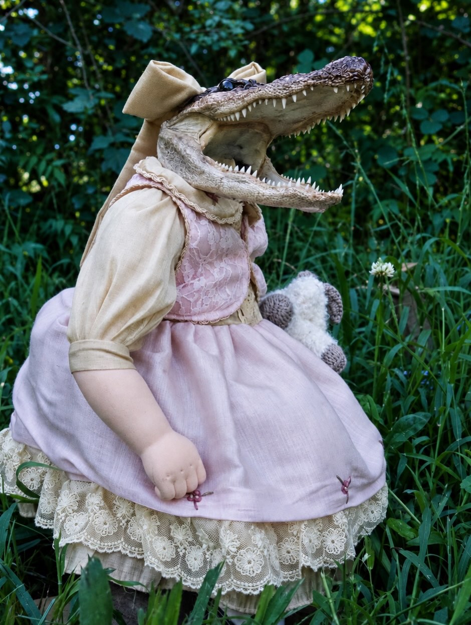 Margret — A vintage porcelain doll with an alligator and her own doll.