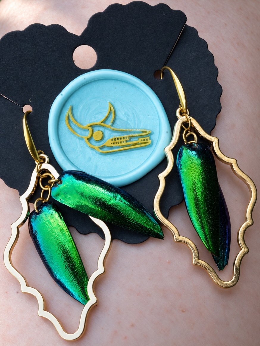 A pair of handmade Scarab Beetle earrings.