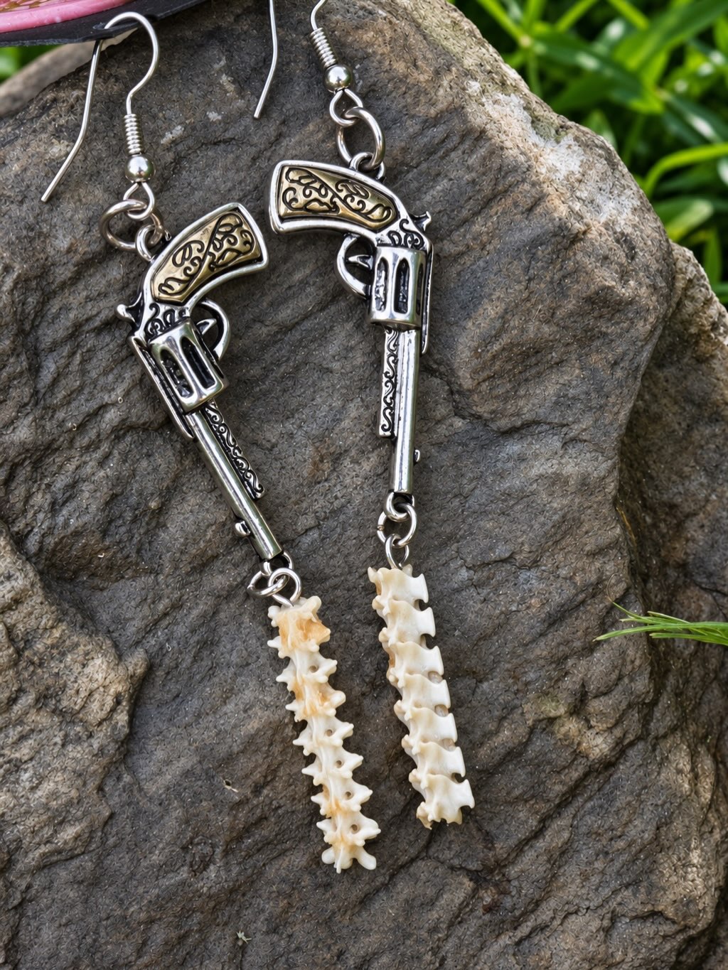 A pair of handmade snake-spine earrings.