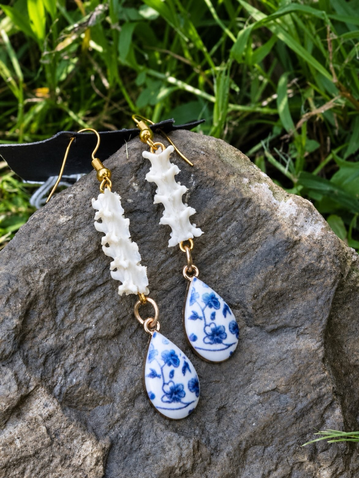 A distinct pair of handmade snake-spine earrings.