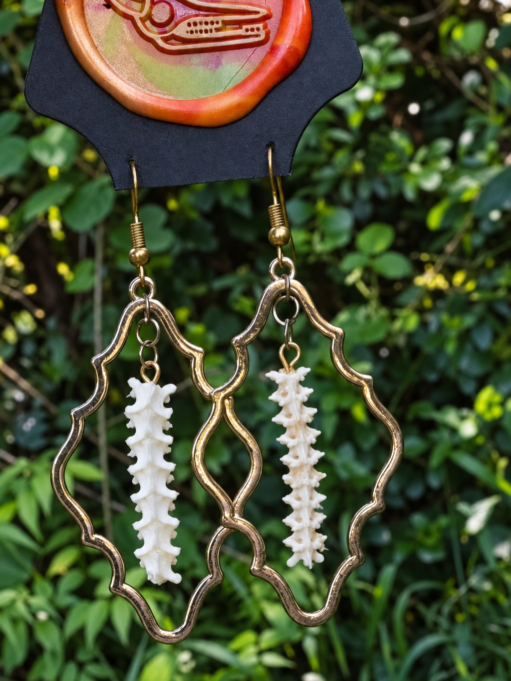 A third distinct pair of handmade snake-spine earrings.